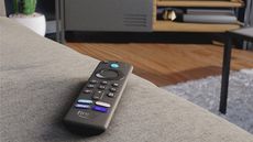 Amazon Fire TV Stick 4K Max remote resting on sofa