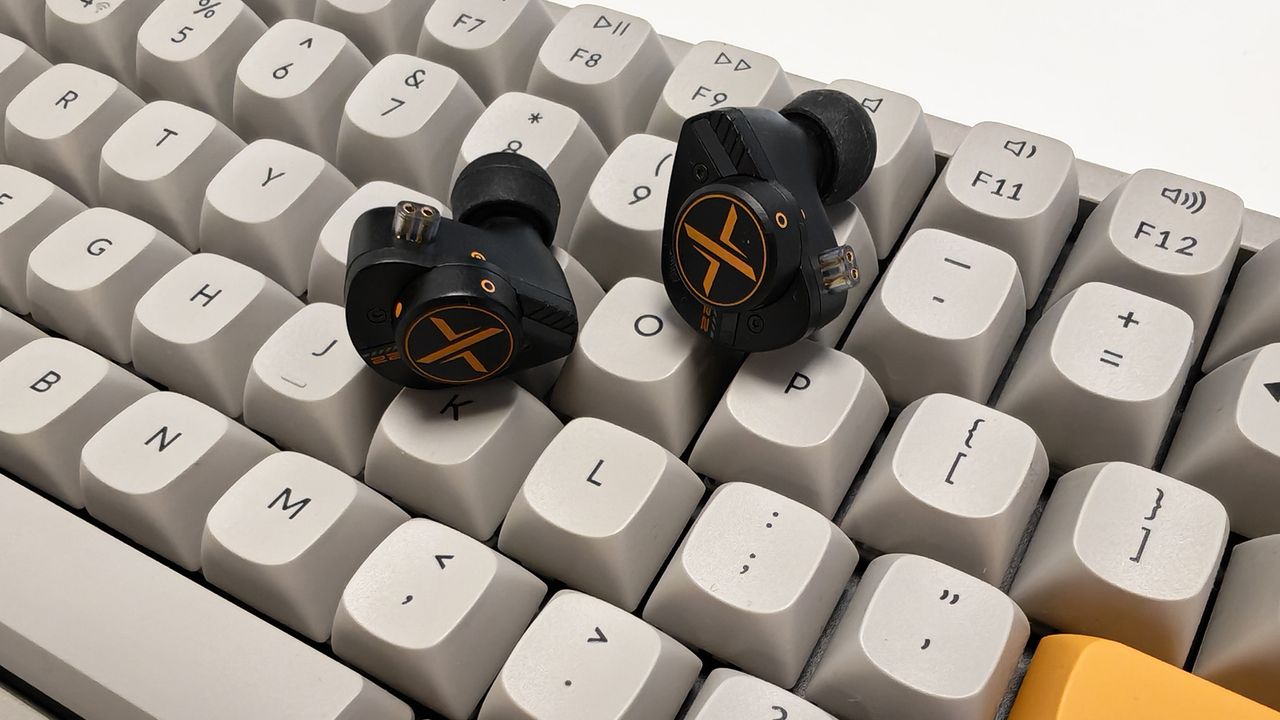 The OoopusX Op.22 earphones on a white desktop.