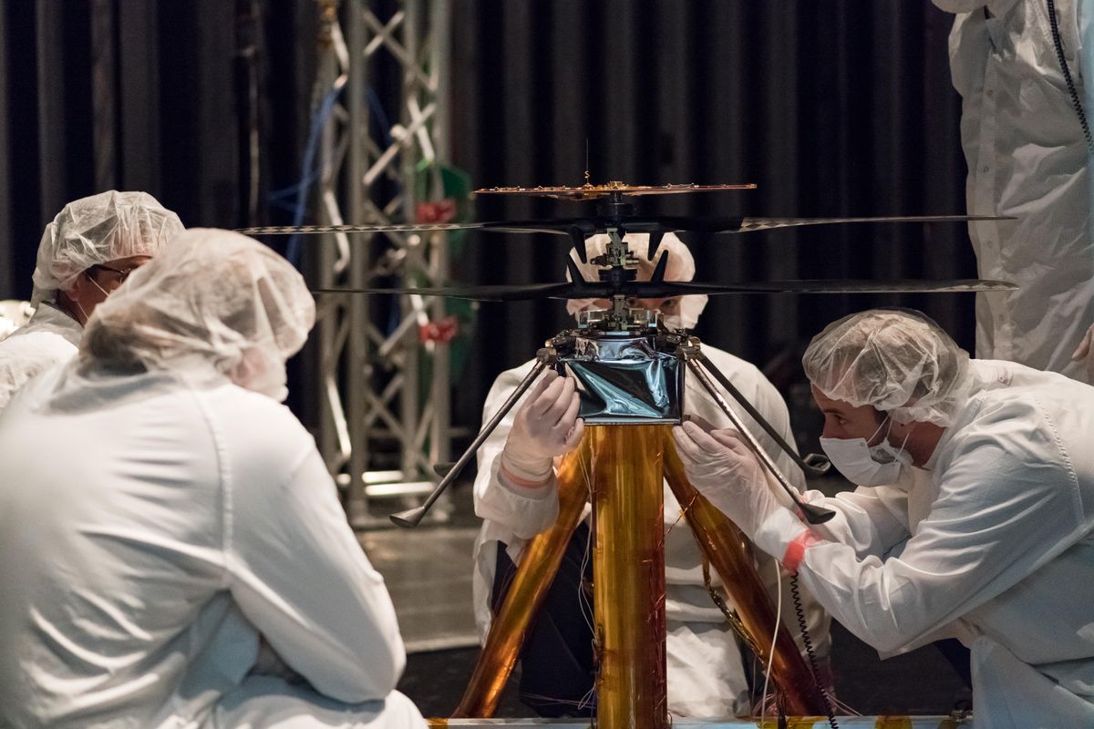 Mars Helicopter team members work the flight model (the vehicle going to Mars) in the Space Simulator, a 25-foot-wide (7.62 meters) vacuum chamber, at NASA&#039;s Jet Propulsion Laboratory in Pasadena, California. 