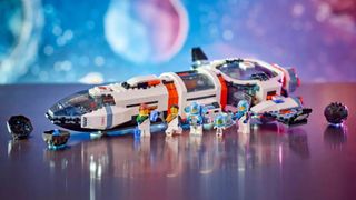 Lego Modular Galactic Spaceship and minifigures on a glossy table, with a cosmic background