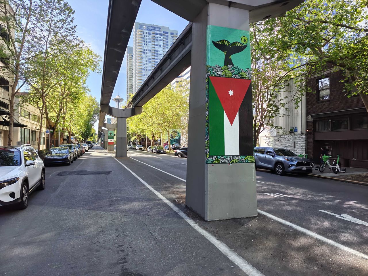 A Palestinian flag on a monorail beam