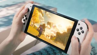 Press image of the White Nintendo Switch OLED showing Breath of the Wild 2