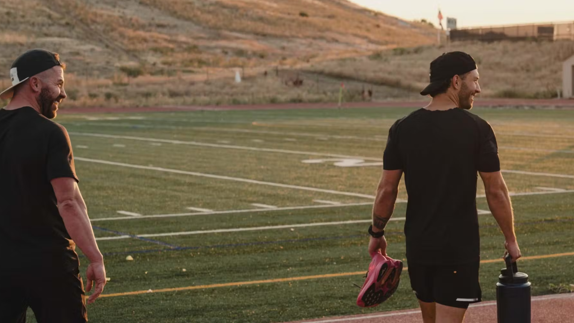 Two men on a running track, one carrying Yeti&#039;s new water bottle 