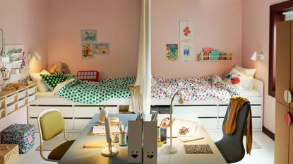 Kids shared bedroom ideas in a pink scheme with symmetrical white beds, drawers and desk areas and colorful bedlinen and accessories.