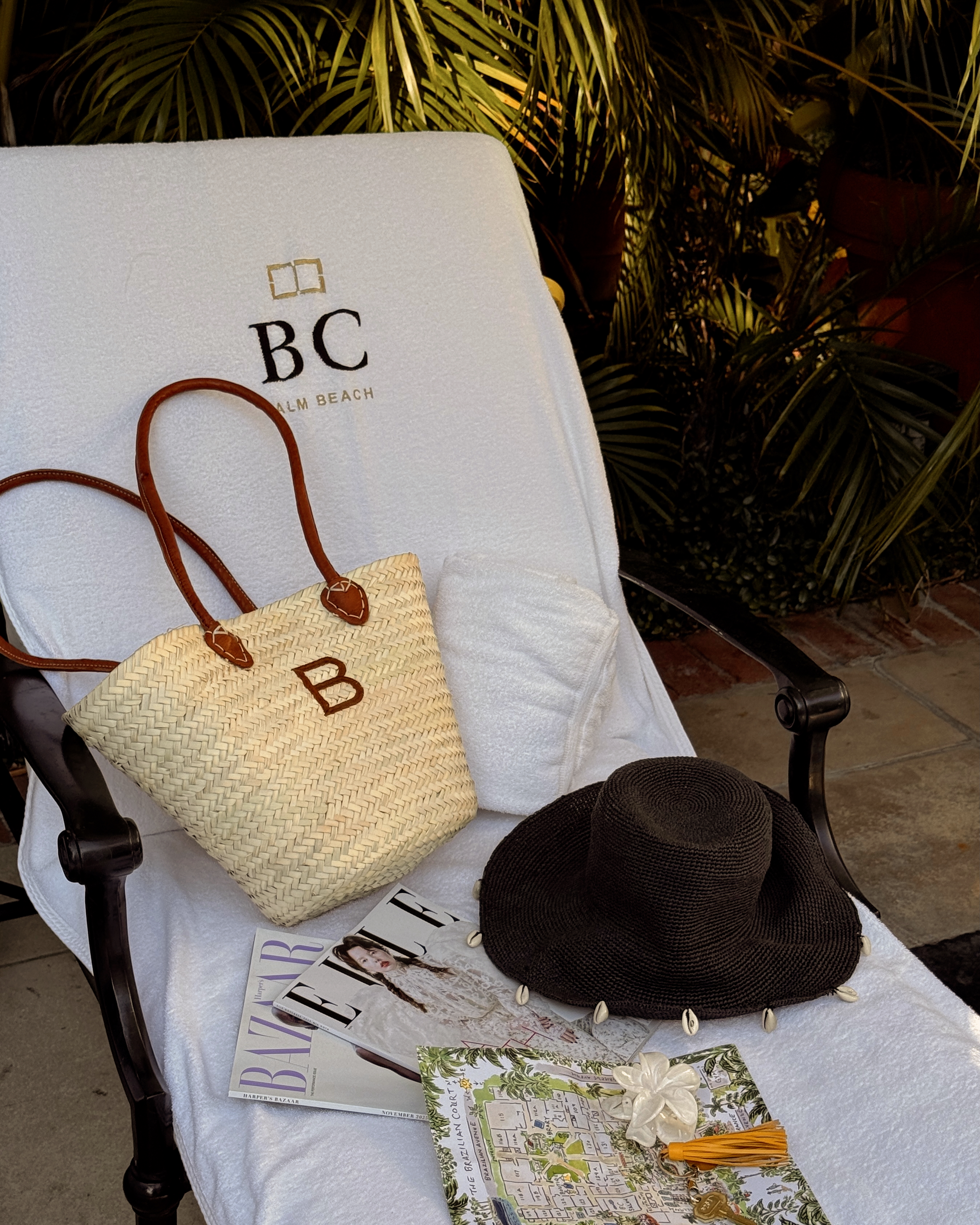Bella Gerard showing her rattan accessories on a pool daybed