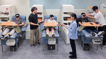 People giving blood while wearing a Samsung Galaxy XR headset