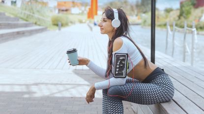 Woman drinking coffee before exercise