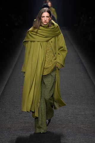 Woman on runway in scarf coat