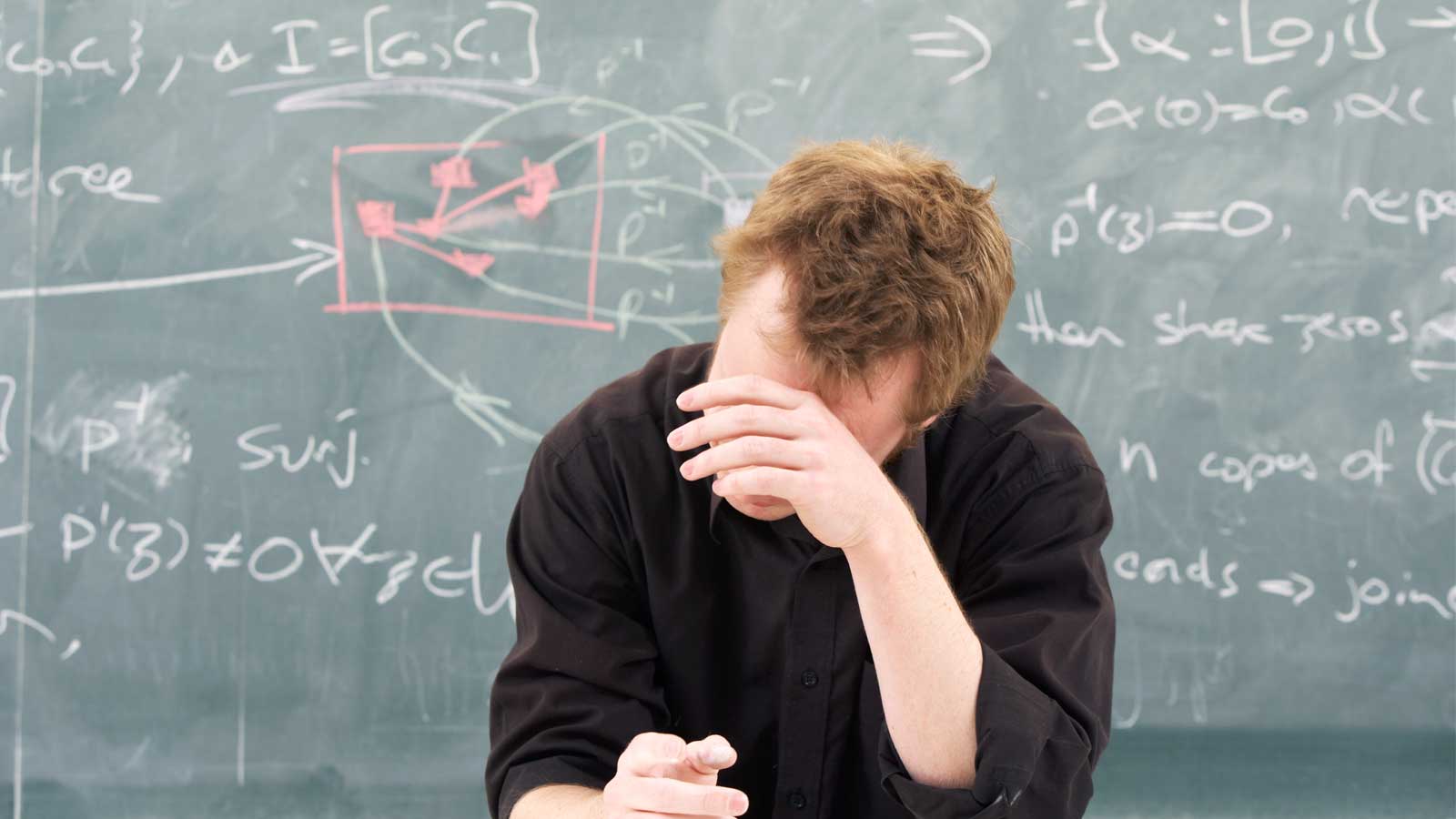Tired mathematician leaning on their arm.