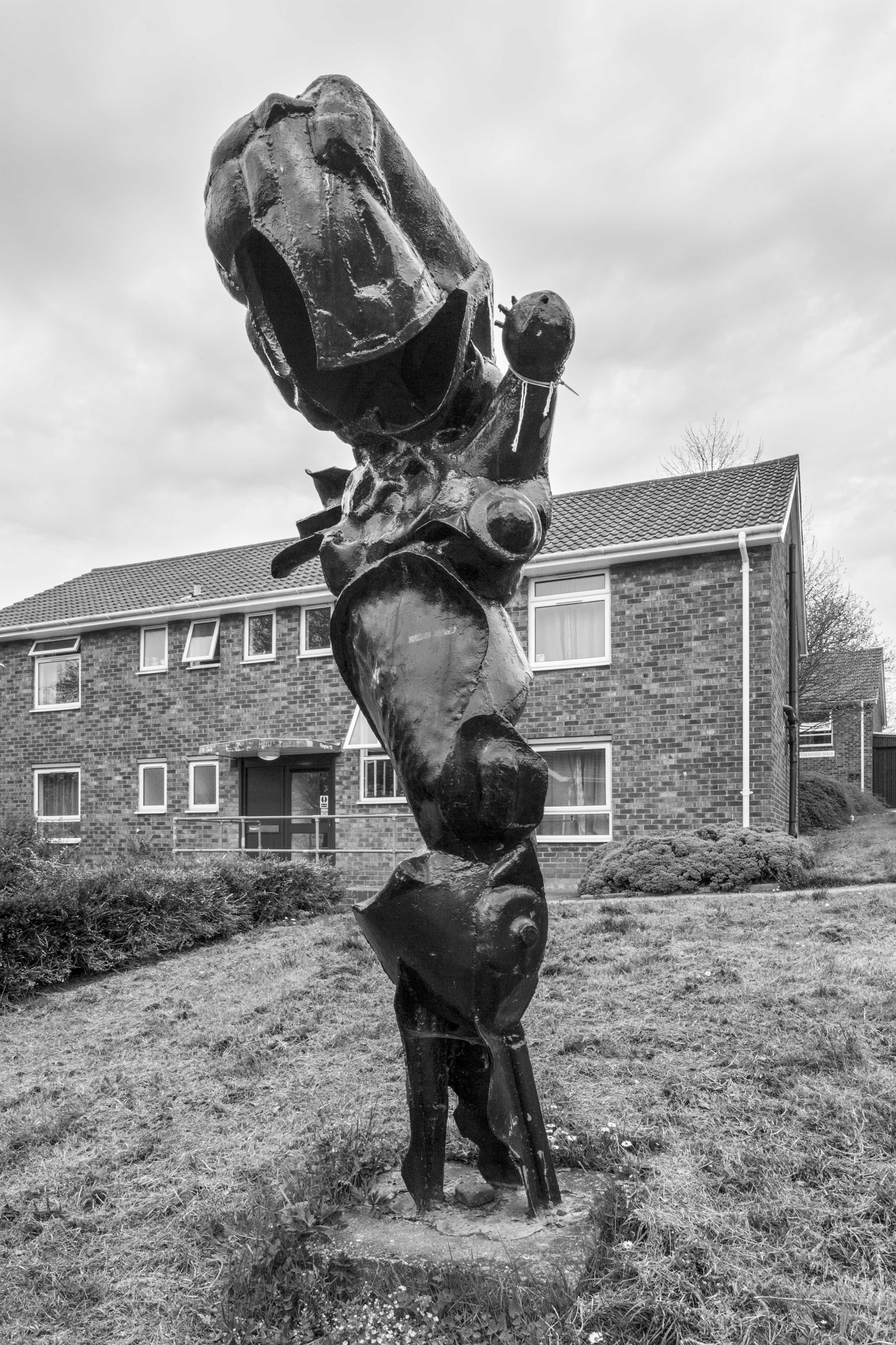 A black & white photo of a tubular and flat steel elements sculpture.