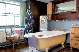 yellow freestanding bath in blue georgian bathroom