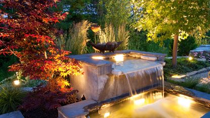 pond ideas with waterfalls: waterfall with lighting in garden