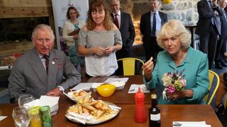 King Charles and Queen Camilla are served fish and chips in Aberdaron during a visit to the Welsh Village on July 5, 2016