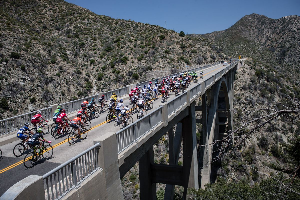 The peloton crosses a bridge along todays route