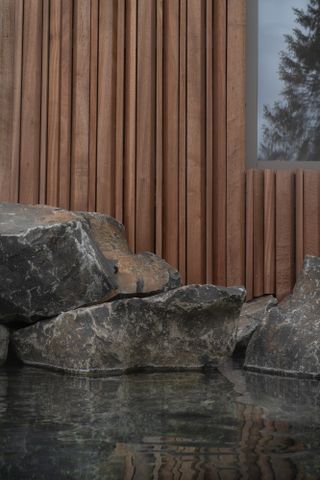Detail view of timber pavilion at forest lagoon geothermal spa in Iceland