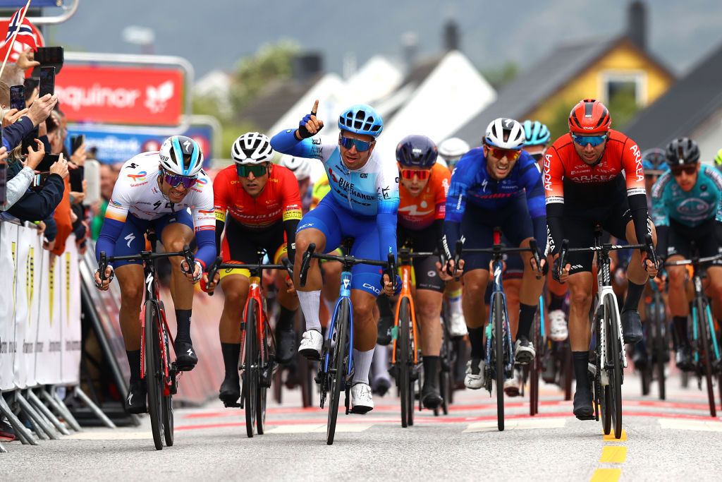 BRONNOYSUND NORWAY AUGUST 12 Dylan Groenewegen of Netherlands and Team BikeExchange Jayco celebrates at finish line as stage winner ahead of Edvald Boasson Hagen of Norway and Team Total Energies L and Amaury Capiot of Belgium and Team Arka Samsic R during the 9th Arctic Race Of Norway 2022 Stage 2 a 1543km stage from Mosjen to Brnnysund ArcticRace on August 12 2022 in Bronnoysund Norway Photo by Michael SteeleGetty Images