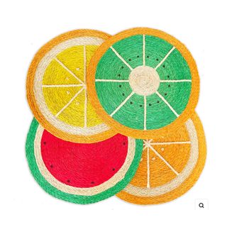 Four placemats patterned with fruit designs