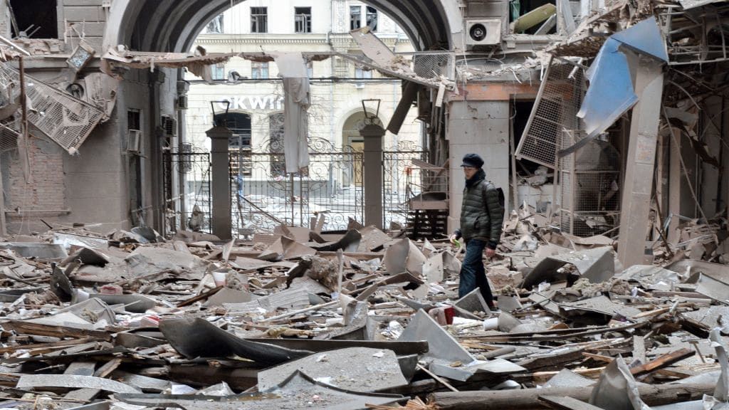 A person walks through rubble in Kharkiv, Ukraine.