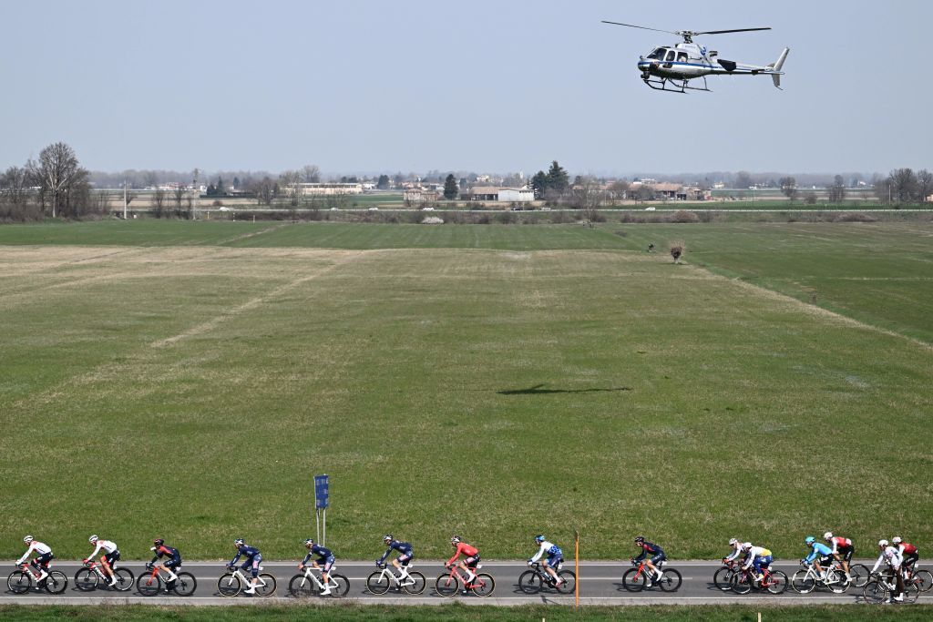 A television helicopter hovers over riders in Casteggio south of Pavia Lombardy during the 113th MilanSan Remo oneday classic cycling race on March 19 2022 between Milan and San Remo northern Italy Photo by Marco BERTORELLO AFP Photo by MARCO BERTORELLOAFP via Getty Images