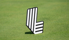 A close-up of a LIV Golf tee marker