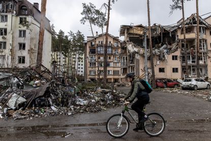 A man rides his bike through Irpin, Ukraine
