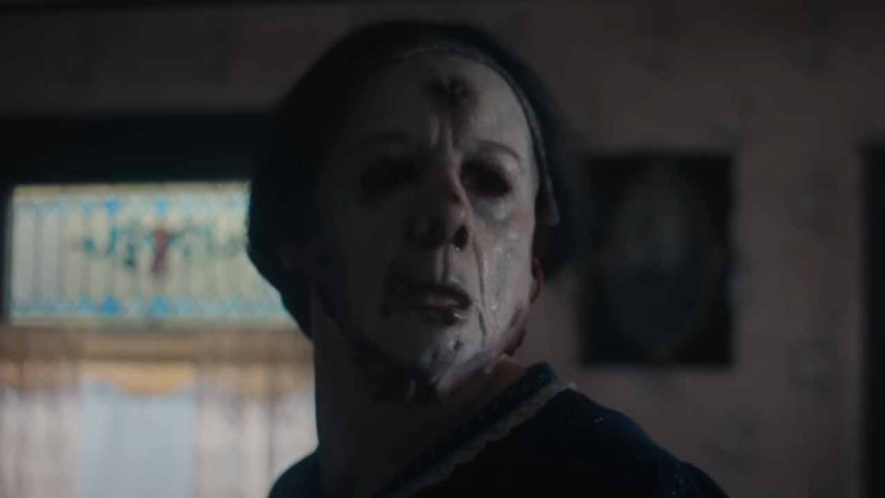 A person wearing a human mask in Monster: The Ed Gein Story