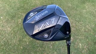 The stunning Srixon ZX 7 MK II Driver held aloft on the golf course revealing its stealthy black colorway and design