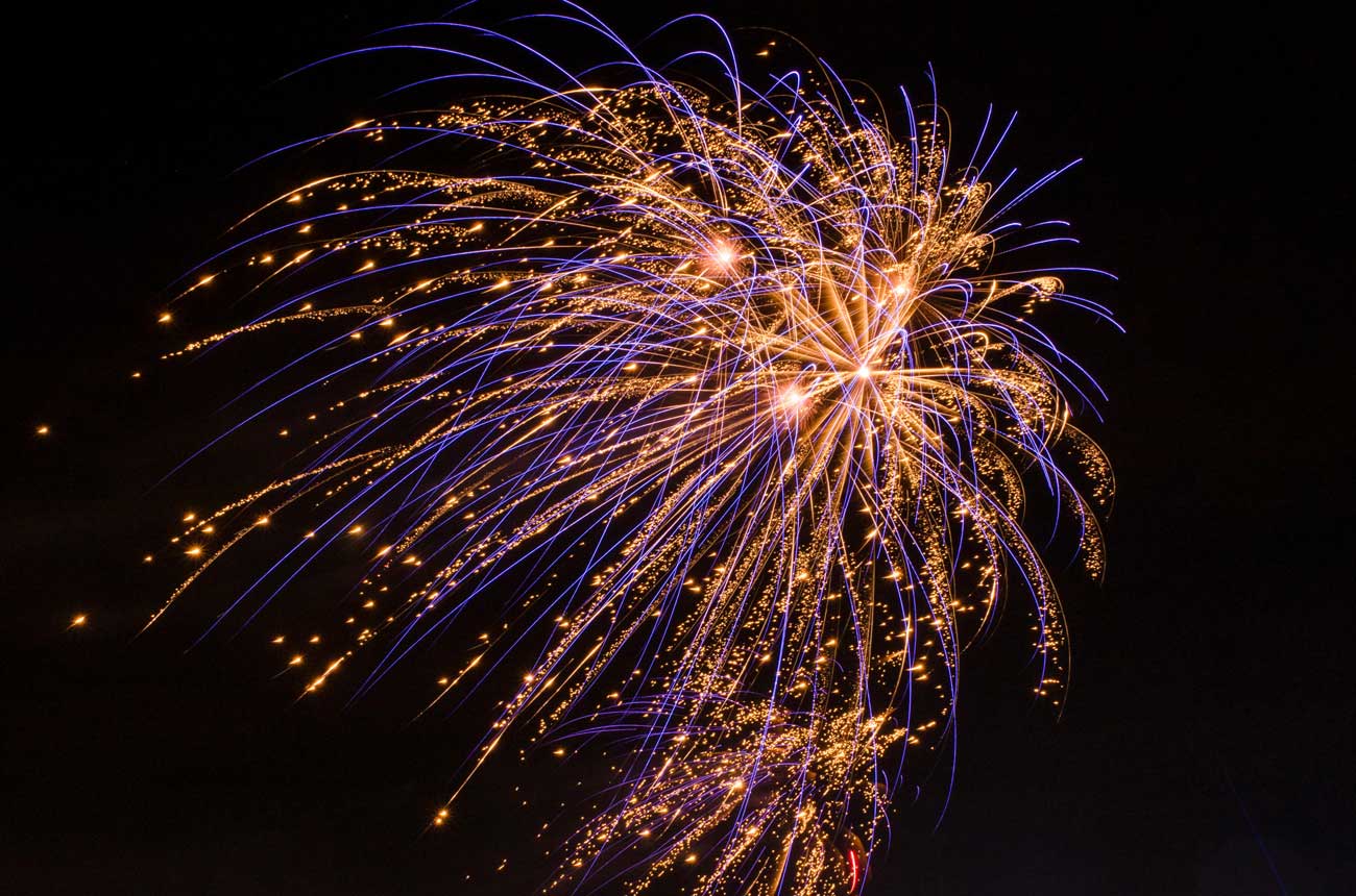 Blue and orange fireworks in the night sky