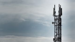 Mobile phone mast against a grey sky