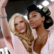 Celebrities pose backstage for photos at the 2025 Victoria's Secret Fashion Show 