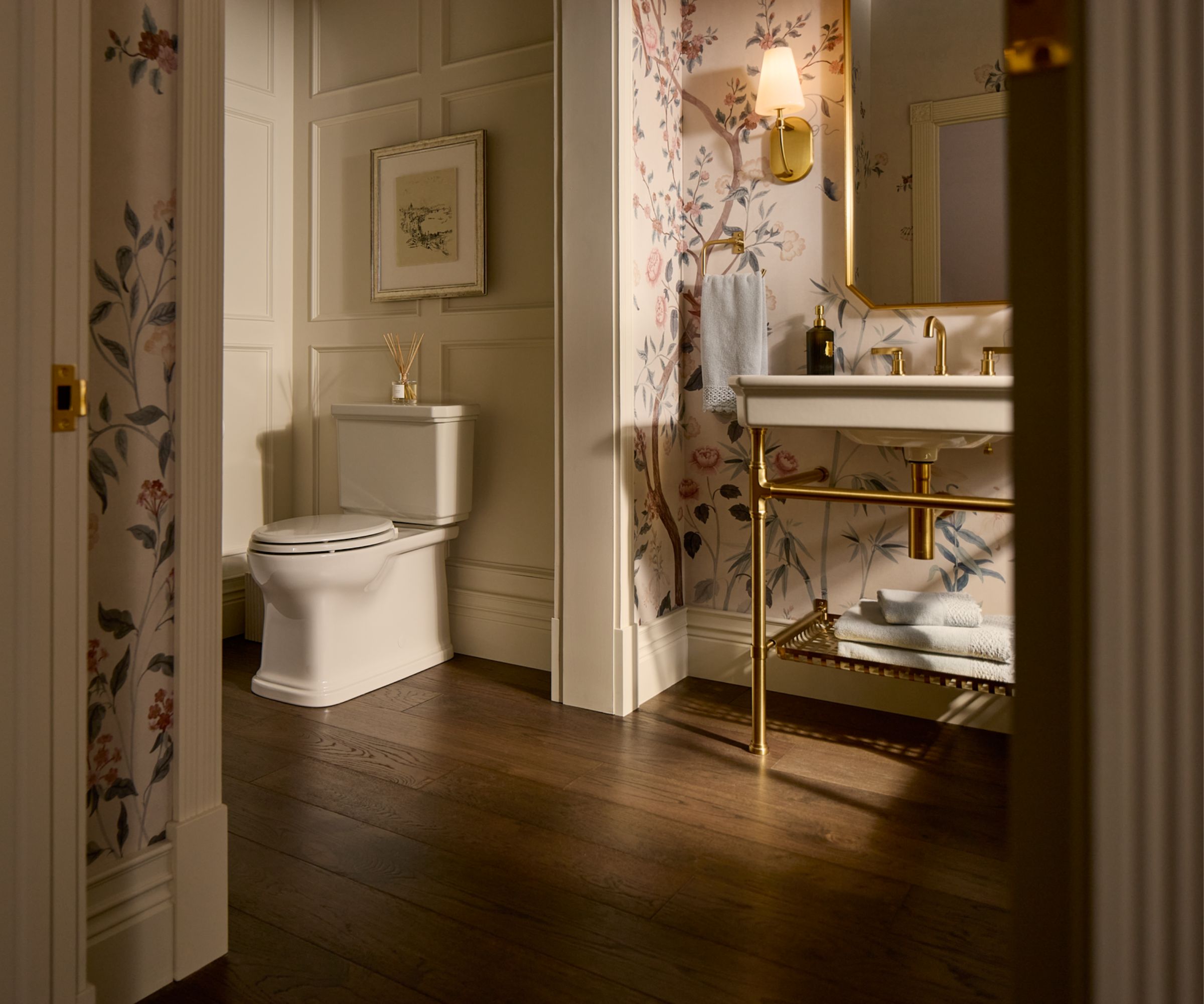 A bathroom with floral wallpaper and a washstand sink