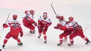 Denmark players celebrate their goal against Canada.