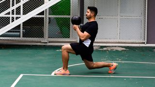 Man performing a kettlebell lunge