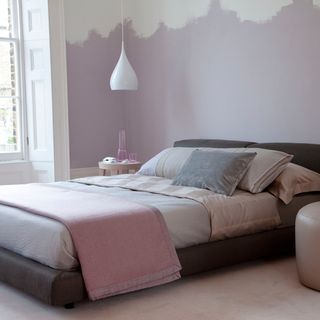 bedroom with pastel colour wall and peach bed