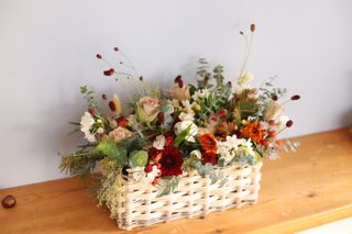 flowers arranged in a basket on a table