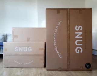 Three cardboard boxes containing the Snug Rebel sofa-in-a-box