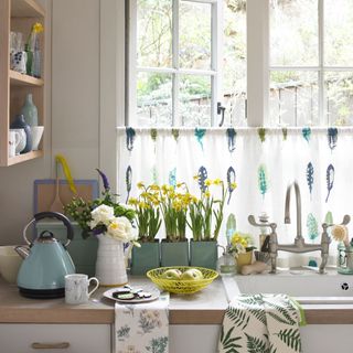 kitchen room with yellow flower vase and white window