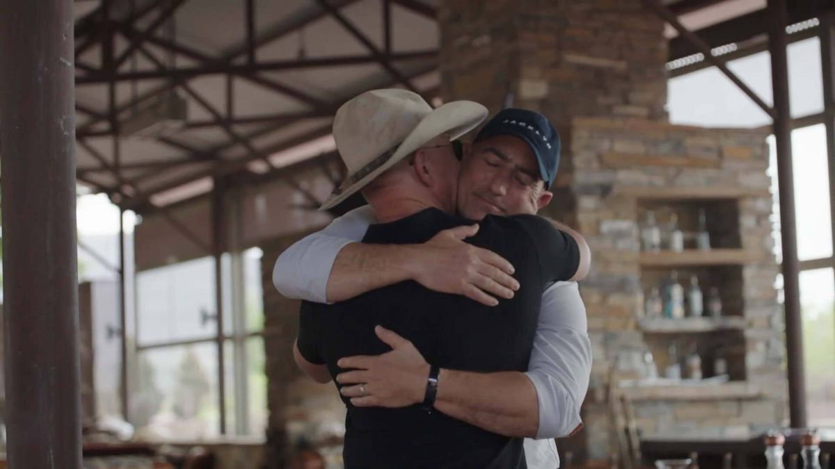 Mark Bezos hugs his brother Jeff. The two will launch to space together on a Blue Origin New Shepard on July 20, 2021.