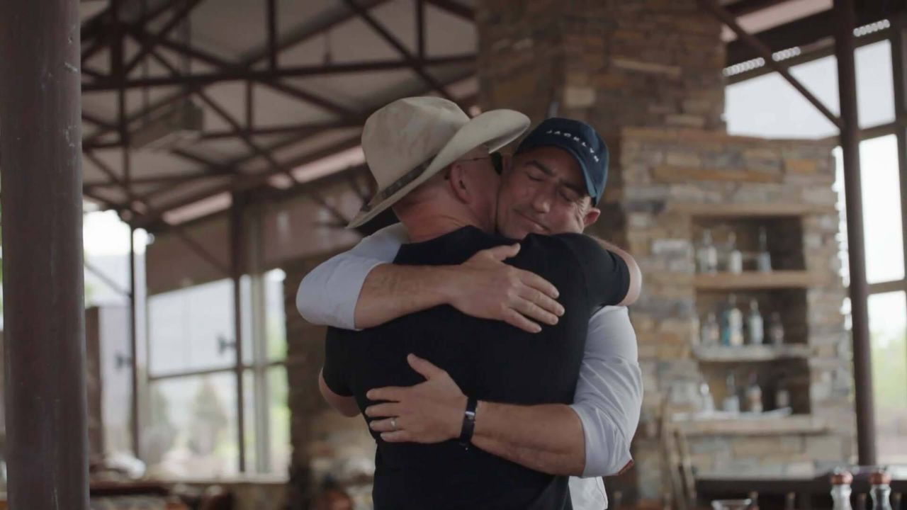 Mark Bezos hugs his brother Jeff. The two will launch to space together on a Blue Origin New Shepard on July 20, 2021.