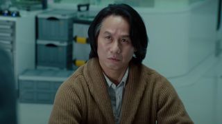 B.D. Wong looking concerned in a lab in Jurassic World: Dominion.