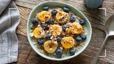 A bowl of porridge with bananas, berries and chopped nuts, drizzled with honey, one of the best weight loss foods