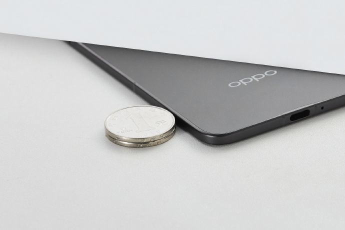 Oppo Find N5 next to a stack of coins