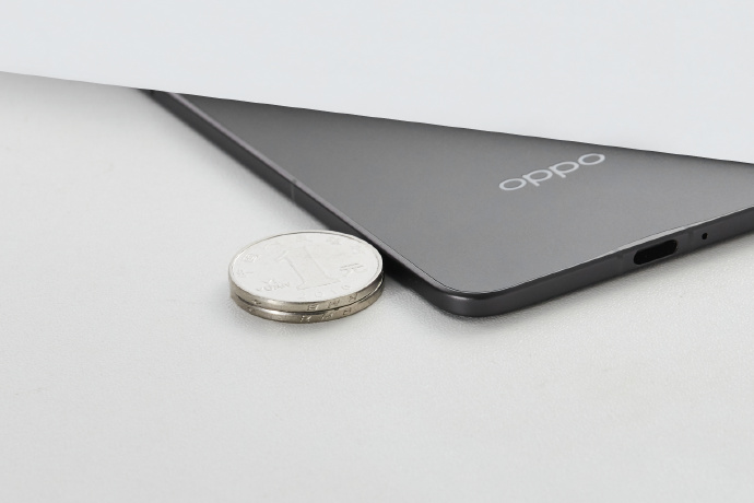 Oppo Find N5 next to a stack of coins