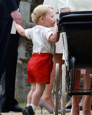 Prince George peering at his new baby sister