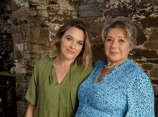 Sally Bretton and Barbara Flynn in character as Martha Lloyd and her mother Anne, standing in front of a distressed brick archway