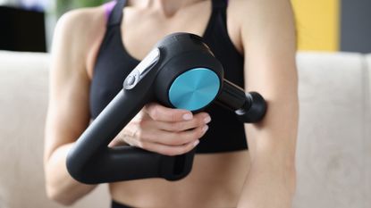 TheraGun massage gun in use