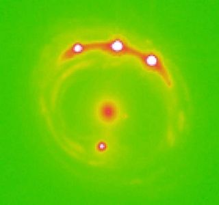 A central "lens" galaxy and four projections of the background quasar RX J1131-1231.