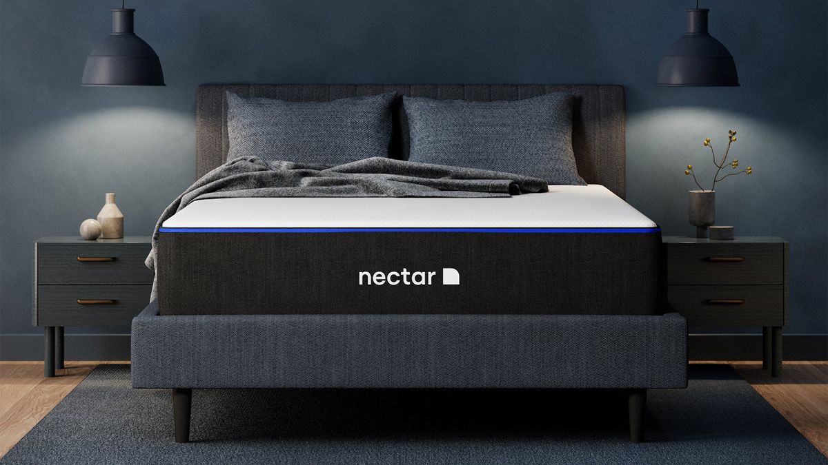 The Nectar Memory Foam Mattress UK on a bed frame in a bedroom, a pillow and blanket on top