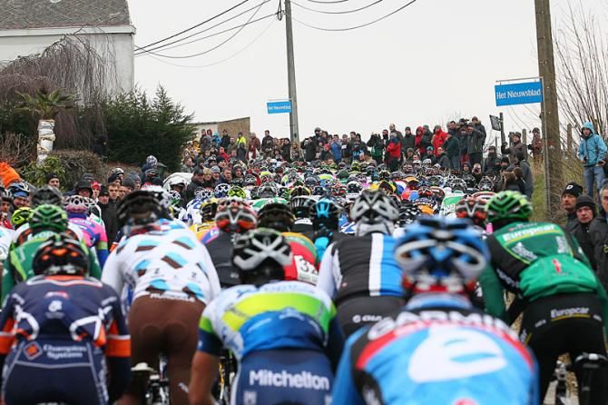 The peloton all tightly packed up on the climb