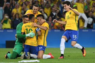 Neymar celebrates with his Brazil team-mates after scoring the winning penalty against Germany in the Olympic men's football final at the Maracana in 2016.